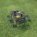 Portable Outdoor Table Set with Stools on Green Grass and Cooking Essentials