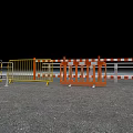 Various Construction Barriers With Yellow Orange And Striped Designs On Gravel Ground
