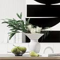 White Vase with White Flowers Green Leaves on Wooden Table with Pears and Artwork