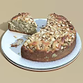 Freshly Baked Round Cake With Nut Toppings On White Plate And Sliced Piece