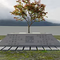 Garden Ornament With Tree Having Red Orange Leaves Stone Pedestal Steps And Stone Paving