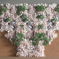 Green Plant Wall With Green Plants White Decorations And Brown Woven Material On Gray Wall