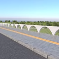 White Arched Railings With Curved Patterns Along Roadside And Green Trees Under Blue Sky