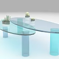 Modern Transparent Glass Coffee Table With Blue Cylindrical Bases And Small Potted Plants