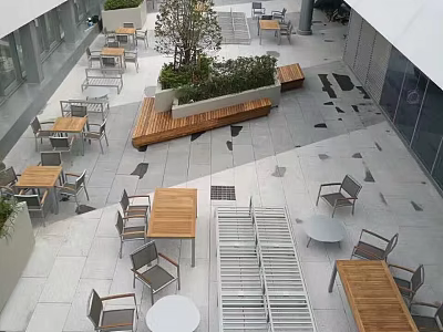 Commercial Street Outdoor Seating Area With Wooden Benches Green Plants And Stone Paved Floor 3d model