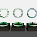 Three Elegant Green And White Jade Bracelets On Black Display Stands