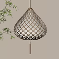 Bamboo Woven Teardrop Shaped Lantern With Warm Yellow Light And Bamboo Leaves