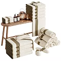 Cozy Bathroom Accessories Set With Soft Rolled And Stacked Towels Wooden Table Candles And Bottles