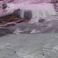 Natural Mountain Stream With Flowing Water And White Foam Over Rocks