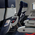Public Chairs In Aircraft Cabin With Dark Blue Seats White Armrests Red Accents