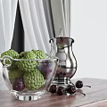 Green Sugar Apples And Purple Plums In Glass Bowl With Silver Container On Table