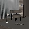 Beige Accent Chair With Round Armrests And Black Legs By Floor Lamp And Side Table