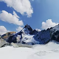 Breathtaking Mountain Landscape With Snow Covered Peaks Blue Sky And White Clouds Scenic View