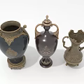 Three Elegant Dark Colored Vases with Gold Accents Handles Lids and Decorative Bases