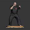 Man In Black Karate Uniform Standing On Decorated Cake Platform In Martial Arts Stance