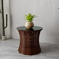 Round Side Table With Woven Rattan Base Black Tabletop And Green Plant Vase