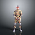 Man in Military Camouflage Uniform with Cap Knee Pads Boots Standing Against Gray Background