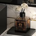 Elegant Fragrance Bottle With White Flowers On Black Base And Marble Background