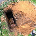Road Infrastructure Construction Site With Excavated Pit Scaffolding And Grass Surroundings On Dirt Ground