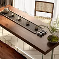 Wooden Tea Table and Rattan Chair with Tea Tray Cups Canisters and Green Plant
