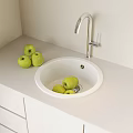 Modern White Washbasin with Silver Faucet on White Countertop Green Apples and White Cabinets