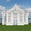 White Building With Glass Roof And Large Windows On Green Grass By Waterfront
