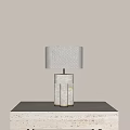 Sleek Modern Table Lamp With Beige Fabric Shade And Geometric Marble Base On Tabletop