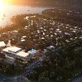 Aerial Planning of Waterfront Residential Area with Sunset View Lush Greenery and Buildings