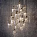 Cluster of Modern Glass Pendant Lights Illuminated Against Industrial Gray Wall
