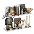 Ornamental Decor Set With Books Candles Pumpkins And Golden Bowl On Shelf