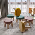 Colorful Mushroom Shaped Stools With Velvet Seats And Wooden Legs In Living Room