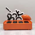 Orange Vase With White And Black Letter Decorations And Round Floral Design