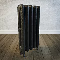 Black Decorative Cast Iron Radiator Against Gray Wall In Room With Wooden Floor