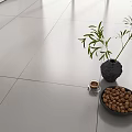 Light Colored Floor Tiles Featuring Black Vase Green Plant Nut Bowl And Small Cup