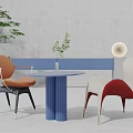 Modern Blue Round Table and Chair Set with Orange Armchair White Red Chair Green Plant