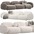 Plush Neutral Colored Three-Seater Sofa With Cozy Blanket And Round Decorative Pillows