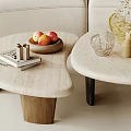 Modern Asymmetrical Coffee Table with Books Fruit Bowl Vase and Candles in Living Room