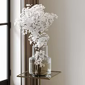 White Floral Bouquet in Transparent Glass Vase on Golden Frame Table by Window