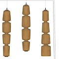 Three Modern Layered Pendant Lights With Textured Cylindrical Shades And Warm Glowing Light