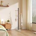 Minimalist Floor Standing Coat Rack With Wooden Hooks And Hanging Clothes In Modern Bedroom