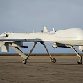 White Unmanned Fighter Drone Flying High In Sky With Long Wings And Payload