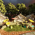 Campsite with Tents Wooden Fence and Tables in Natural Setting Under Red Sunset Sky