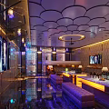 Luxury KTV Interior With Modern Decor Colorful Lighting LED Screens And Sofa Seating