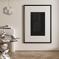 Black Framed Abstract Painting In Modern Interior With Beige Wall And Decorative Side Table