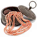 Vibrant Orange Beaded Necklaces With Black Dotted Jewelry Boxes And Intricate Details
