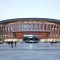 Contemporary Hospital Building With Curved Wooden Facade And Spacious Plaza Entrance