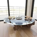 Transparent Glass Coffee Table With Wooden Base In Room With Large Windows And Wooden Floor