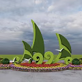 Circular Colorful Flower Bed And Planters With Green Sail Shaped Sculptures In Lawn Garden