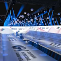Modern Stage With Blue Lighting Hanging White Spherical Decorations Staircase Seats And Brand Logos Backdrop