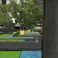 Modern Residential Landscape With Lush Trees Greenery Water Feature Flower Beds And Paved Area